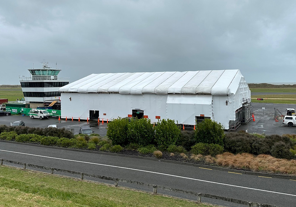 Front view of Whanganui Airport's terminal covered in a construction tent during its reroofing process