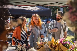 Visitors to the Whanganui River Markets check out the flower stall
