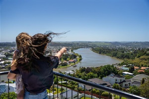 A woman and a young child look out over Whanganui from the viewing platform at the Durie Hill look-out